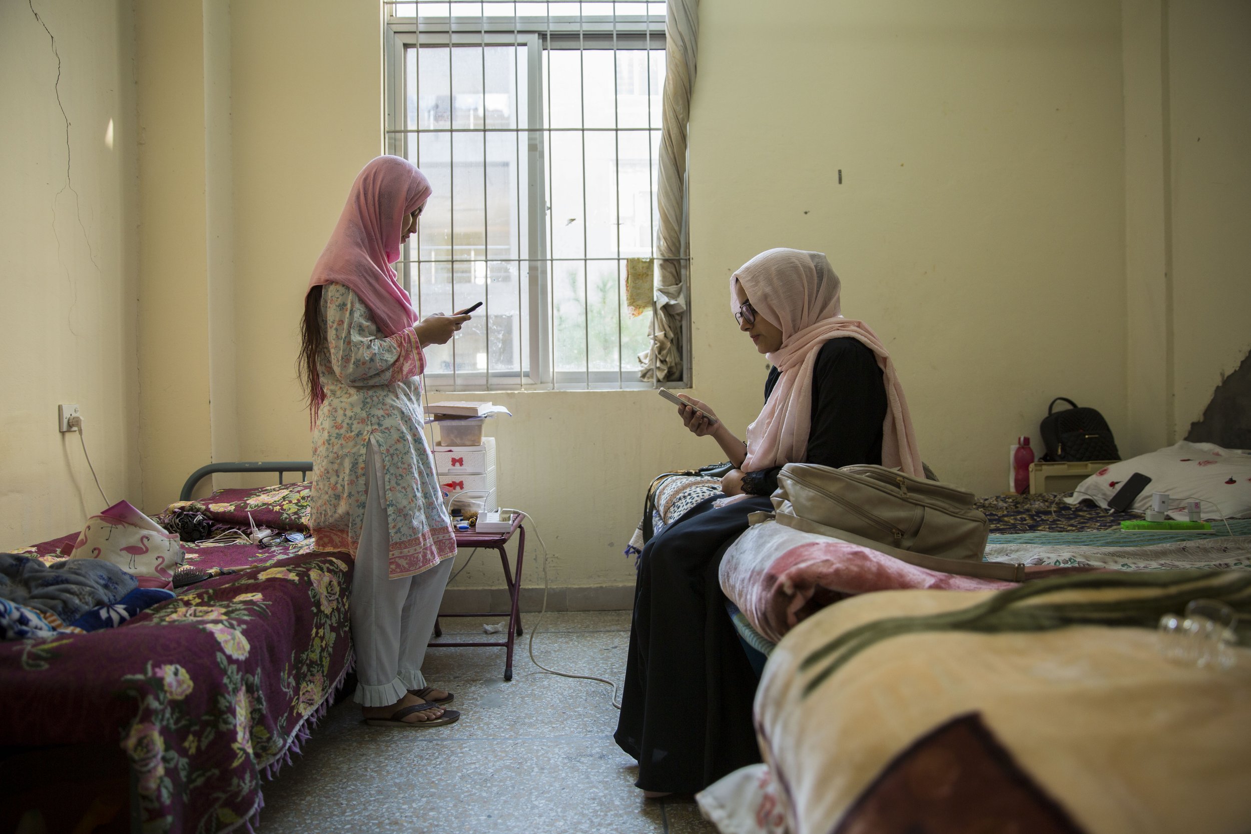  Bibi and her roommate, Sana Arif, hang out in their dorm before class. 