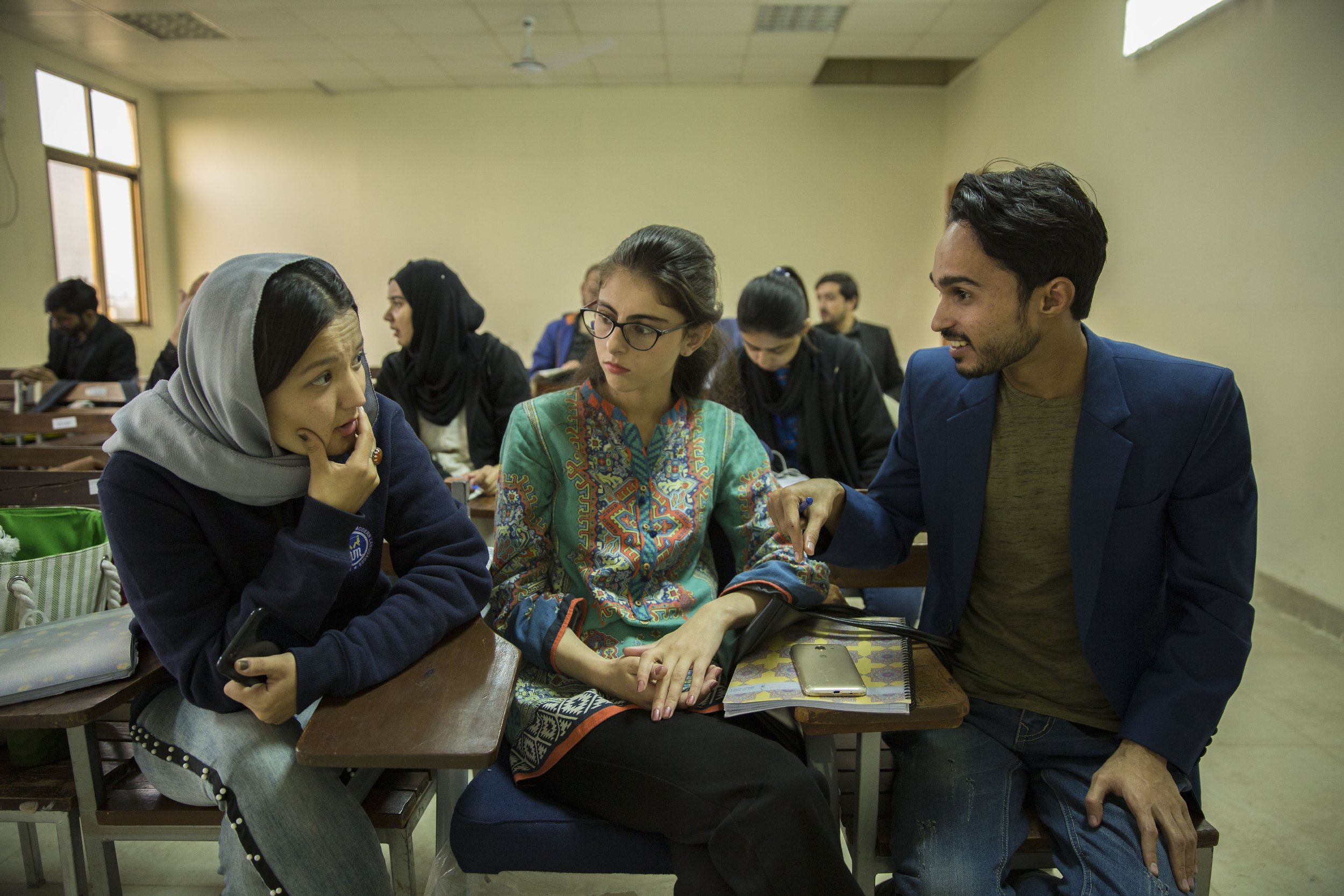  Haleema, 22, at left, chats with classmates during poetry class. 