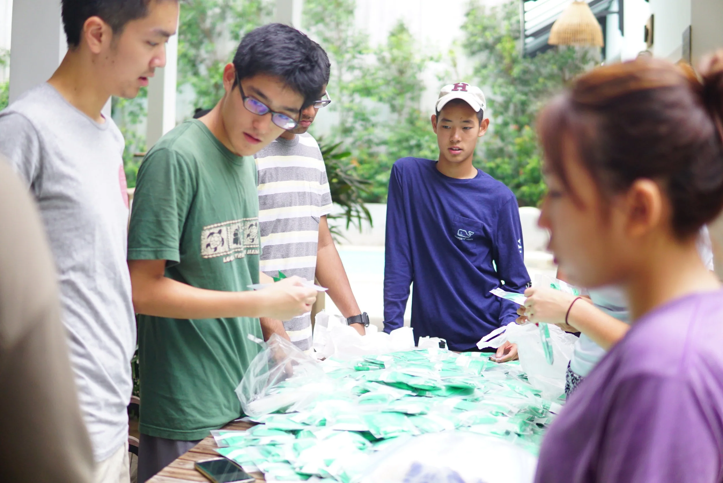 Wilson sorting medicine to be distributed to children and villagers of the TASSEL community. 