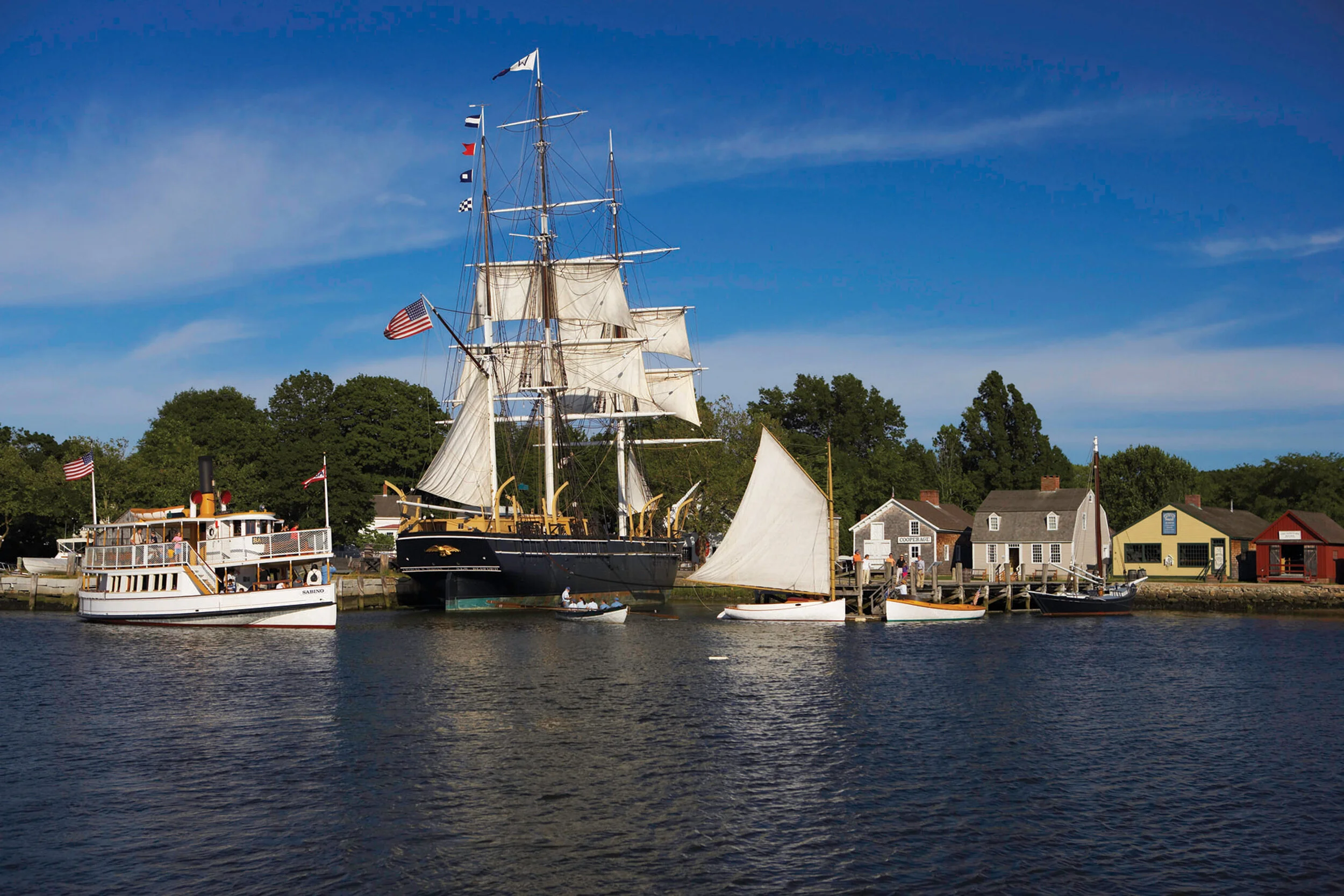 The Charles W. Morgan (middle), the last remaining American wooden whaling vessel, on the docks of Mystic Seaport. Photo: Mystic Seaport Museum.