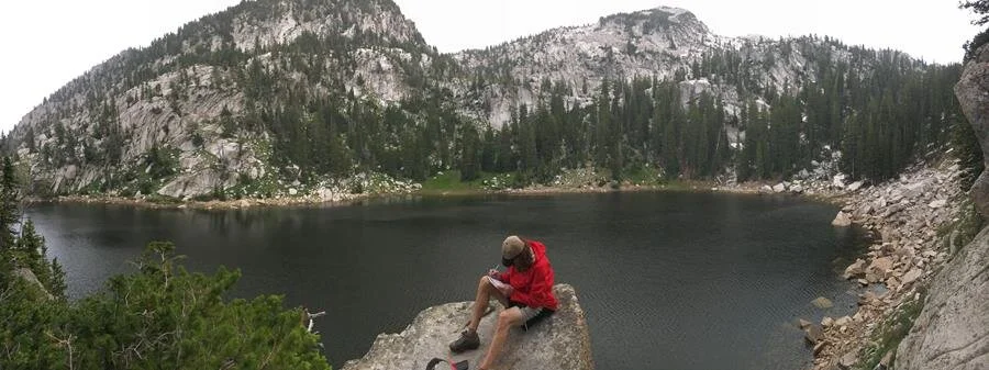 A volunteer surveys an alpine site for boreal toads.