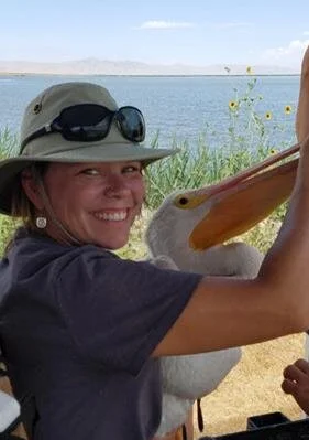 Jaimi Butler, incoming Board Chair, with two of her passions: pelicans and Great Salt Lake