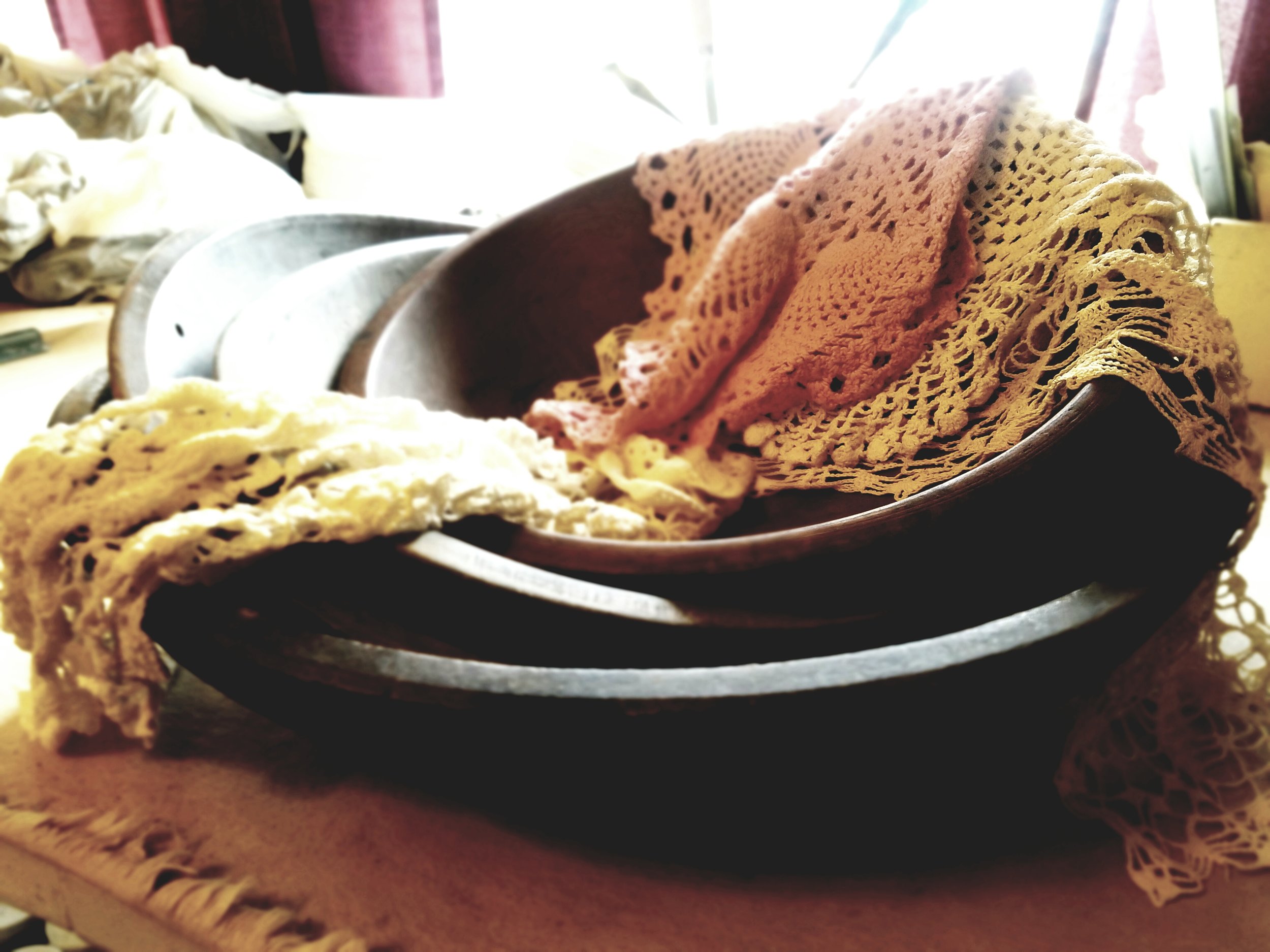 VINTAGE LACE PROVIDES TEXTURE, WHILE ANTIQUE WOODEN BOWLS, SCONCES, AND OTHER INTERESTING ANTIQUE PIECES CREATE MOLDS.