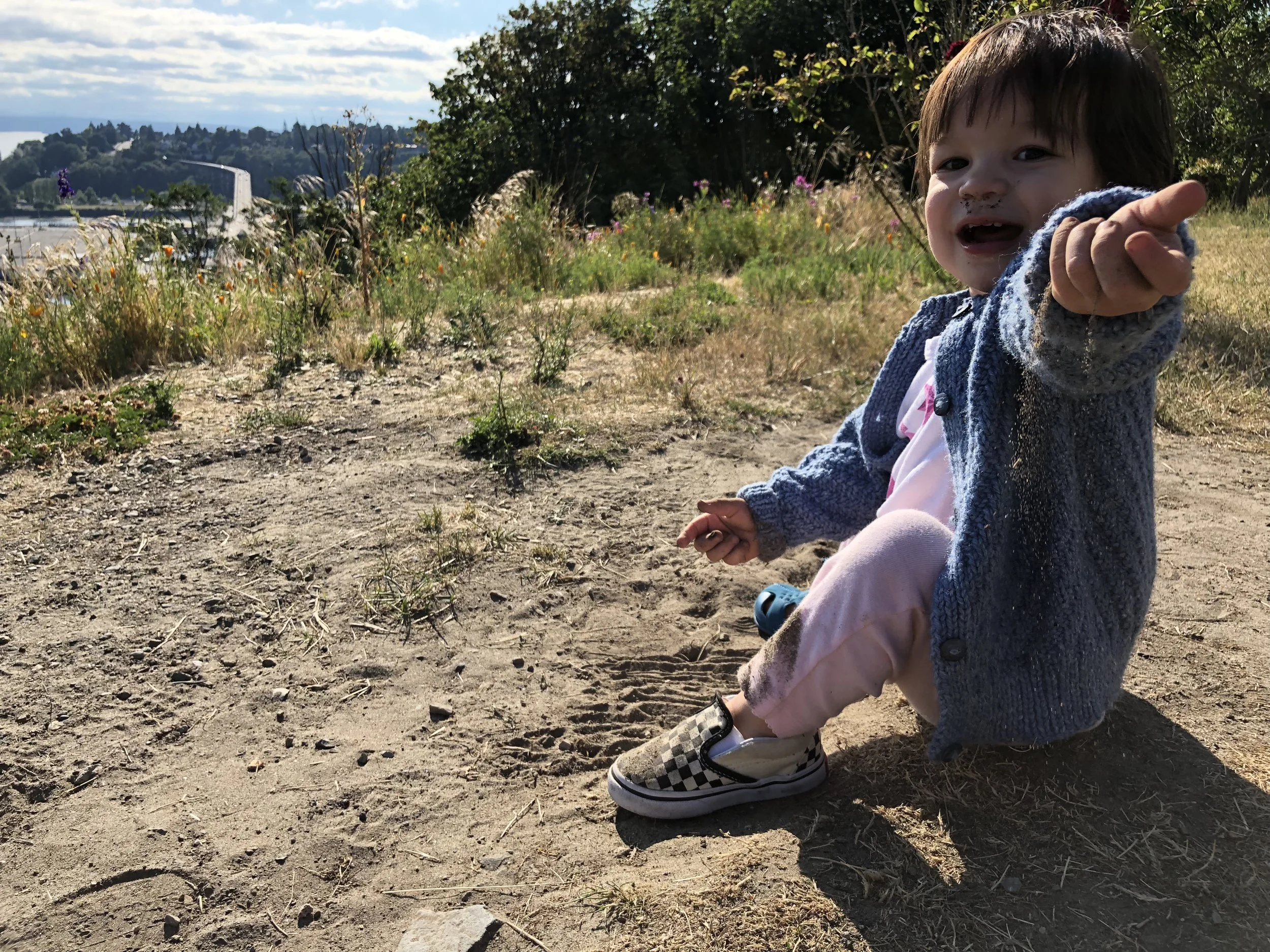Sifting dirt through her fingers