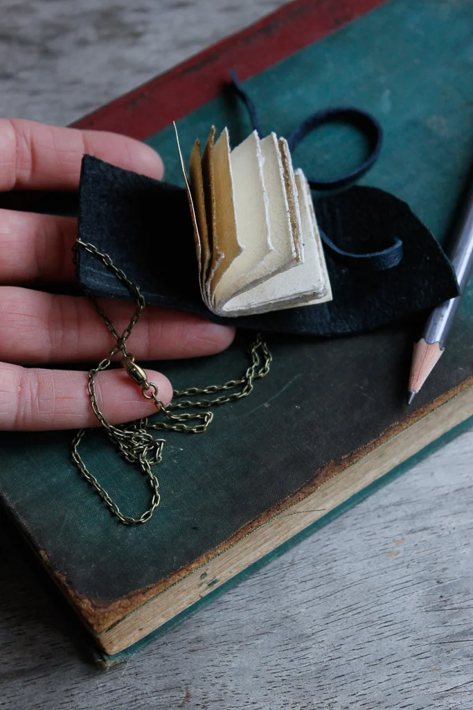Wearable metallic silver book necklace
