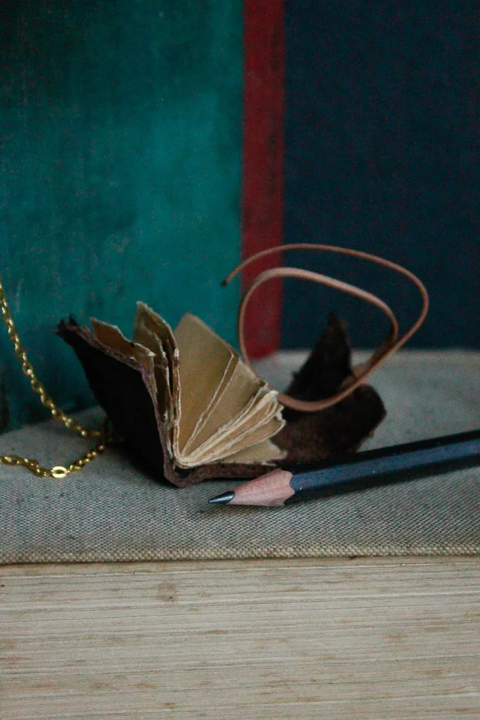 Cacao | Miniature leather book necklace with hemp drawing paper