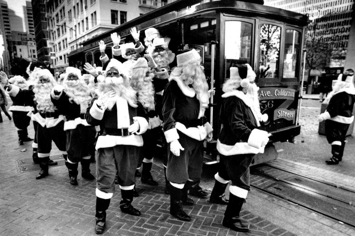 Santa’s swarm a cable car near the Powell St. turnaround in 1987.