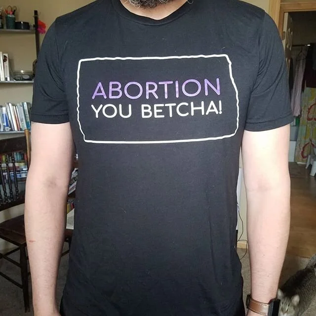 Fashion Show!
Our new merchandise features the &quot;You Betcha!&quot; shirt, sweatshirts that have a cozy, unisex fit, and two new beanies!
You can order these items for a no-contact delivery in the FM area right now through our&nbsp;virtual Fund-A-Thon event! Here's how to order: -Email&nbsp;info@ndwinfund.org&nbsp;with the item(s) you would like, your size, and the best way to contact you. Then make your donation at&nbsp;http://ndwinfund.org/donate
- Make a suggested donation on our donate page. In the Tribute Field, include the same information (item, size, contact information)
- Reply to this or any of our social media posts about the new merch, or DM our social page (again with item, size, and contact information). Then make your donation on our donate page
Suggested donations for the items are:
- $20 for Beanies (One Size)
- $20 for Shirts (XS, S, M, L, XL, XXL)
- $40 for Sweatshirts (XS, S, M, L, XL, XXL)
And we hope to see next Sunday, April 26 at 4pm for our Virtual Fund-A-Thon event featuring a screening of the 32-minute documentary Undue Burdens!