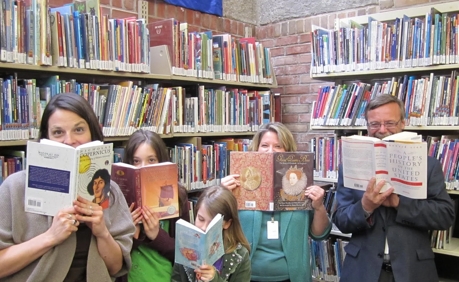 People hiding behind books.JPG