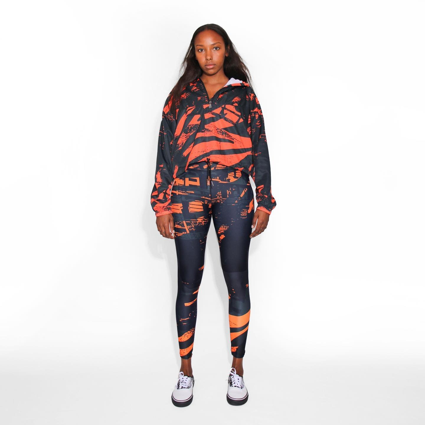 N&deg;11, Urban collection: A three-piece composition: jacket, top and leggings, featuring a version of our signature print, with orange (also available with green). Mix and match with different items and colors, or wear them all together, for a beau