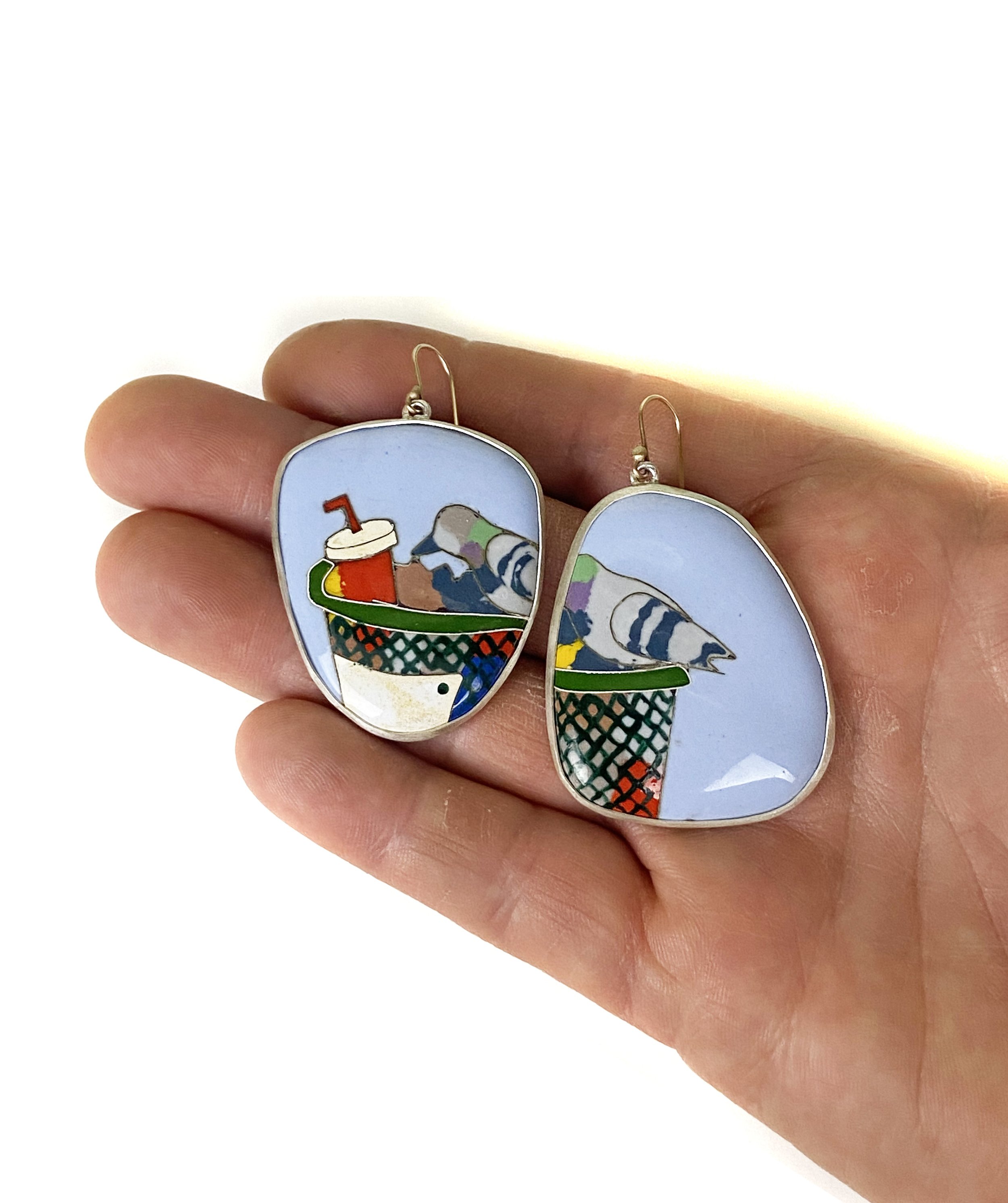 Trash pigeon earrings hand.jpg