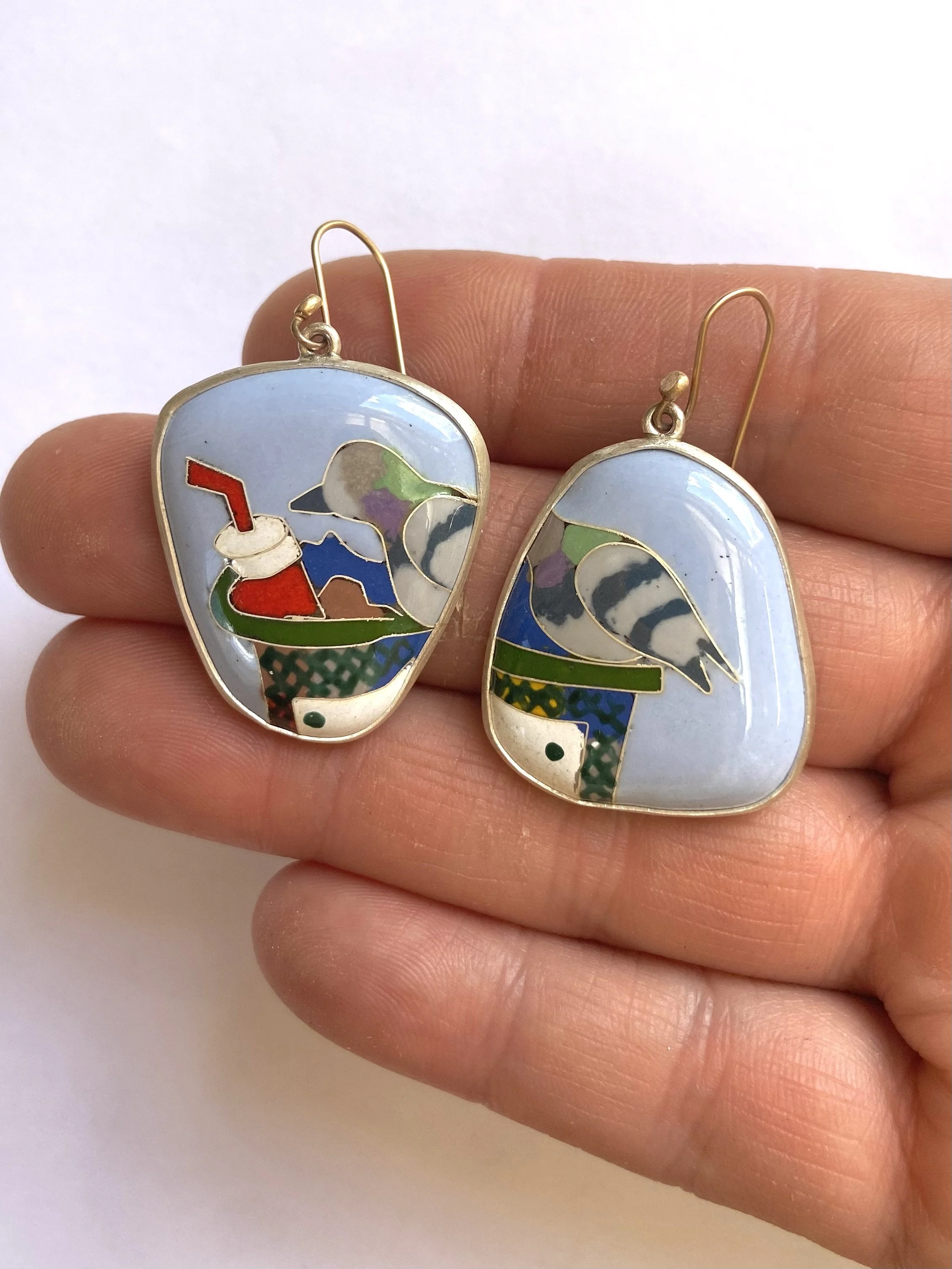 Small pigeon earrings hand.jpg