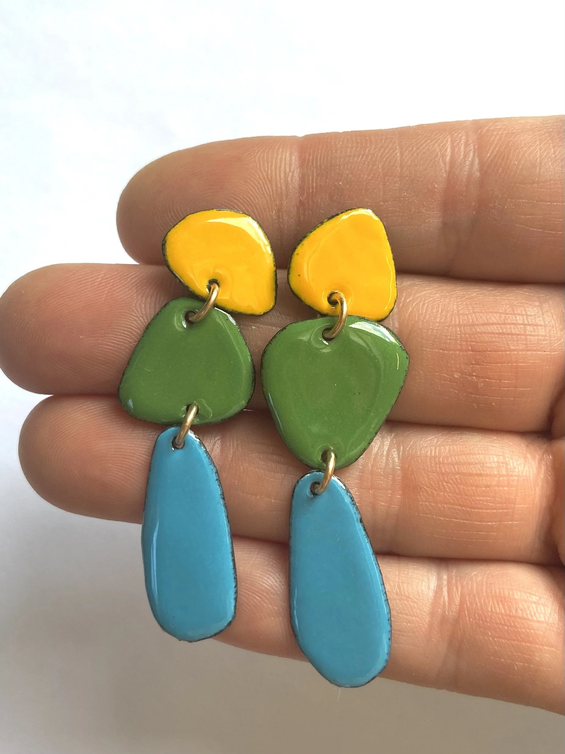 Long skinny caveman earrings hand.jpg