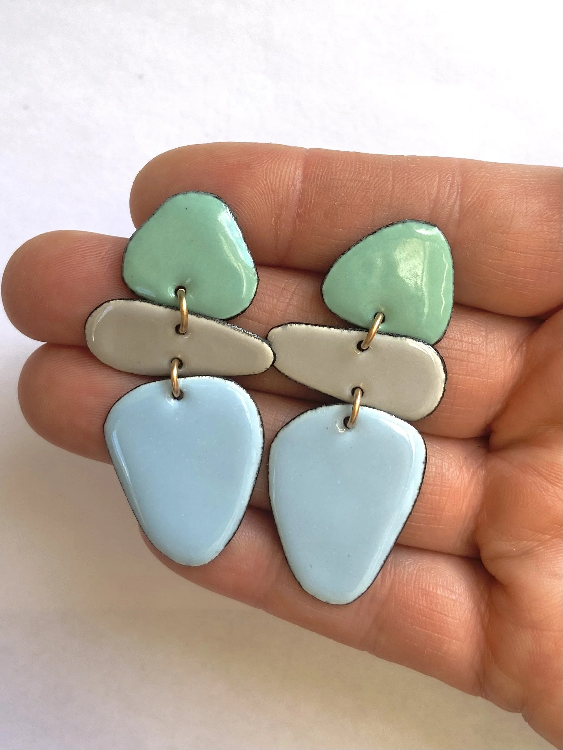 Caveman earrings pastel hand.jpg