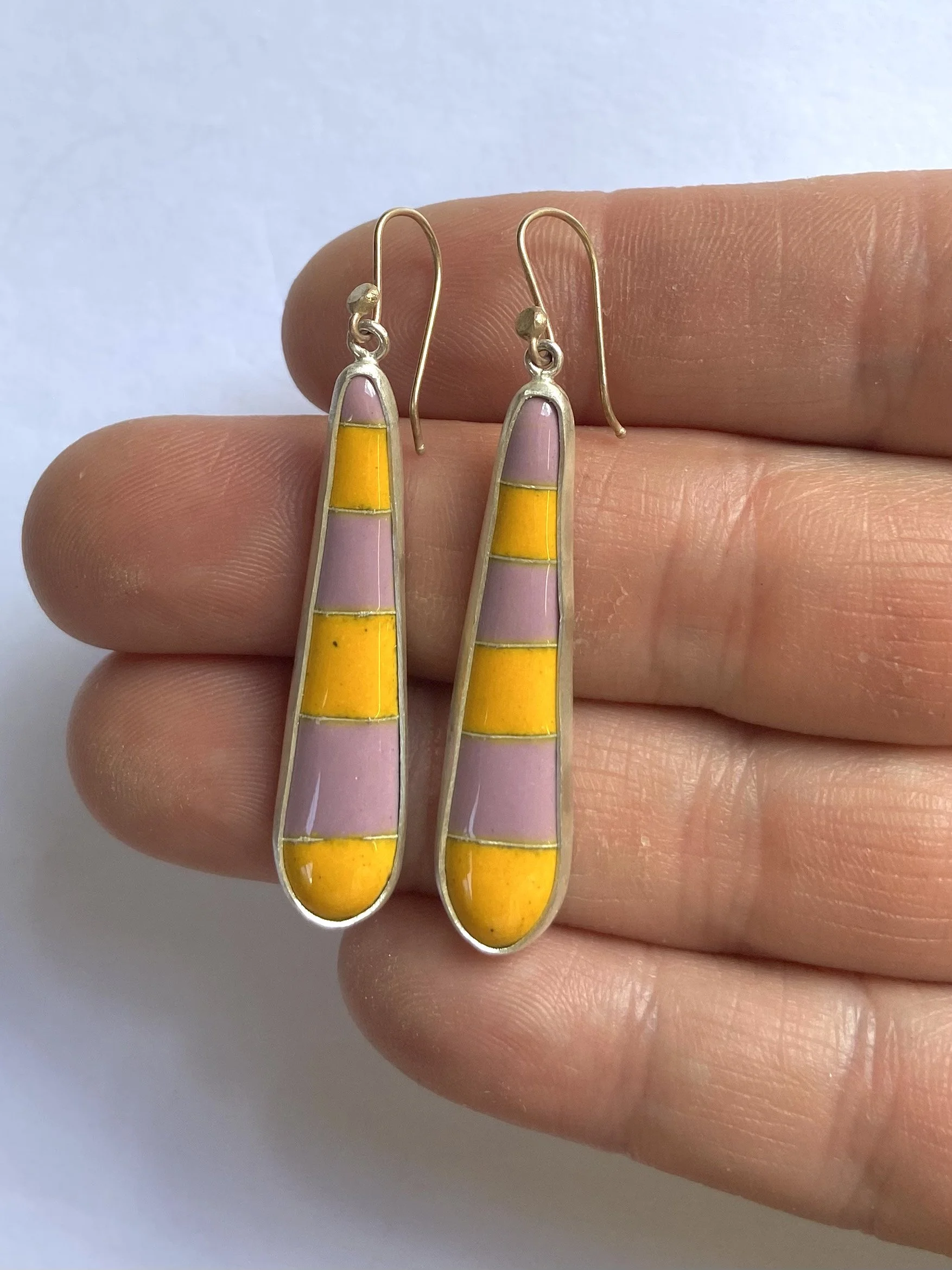 pink yellow stripe earrings hand.jpg