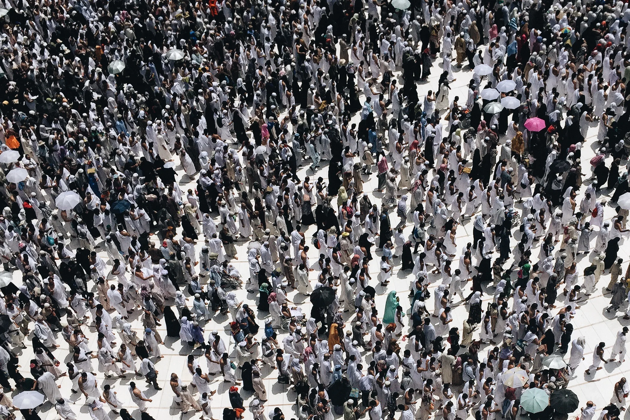 Pilgrims perform the Tawaaf ritual, circumambulating the Kaaba seven times counter-clockwise.