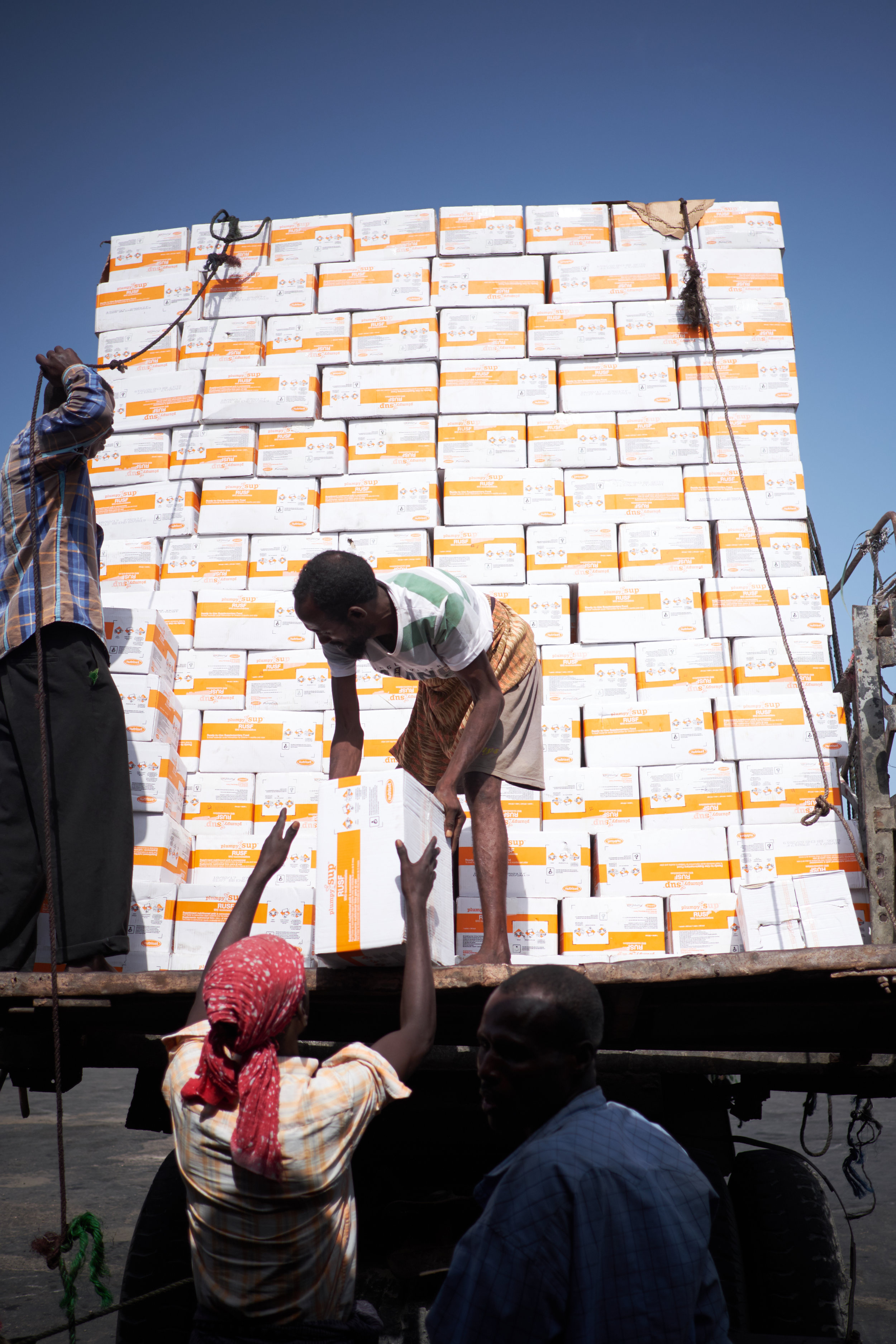 Men unload a shipment of Plumpy'nut, a ready-to-use, high-energy peanut paste that is one of the most effective weapons in the fight against malnutrition.