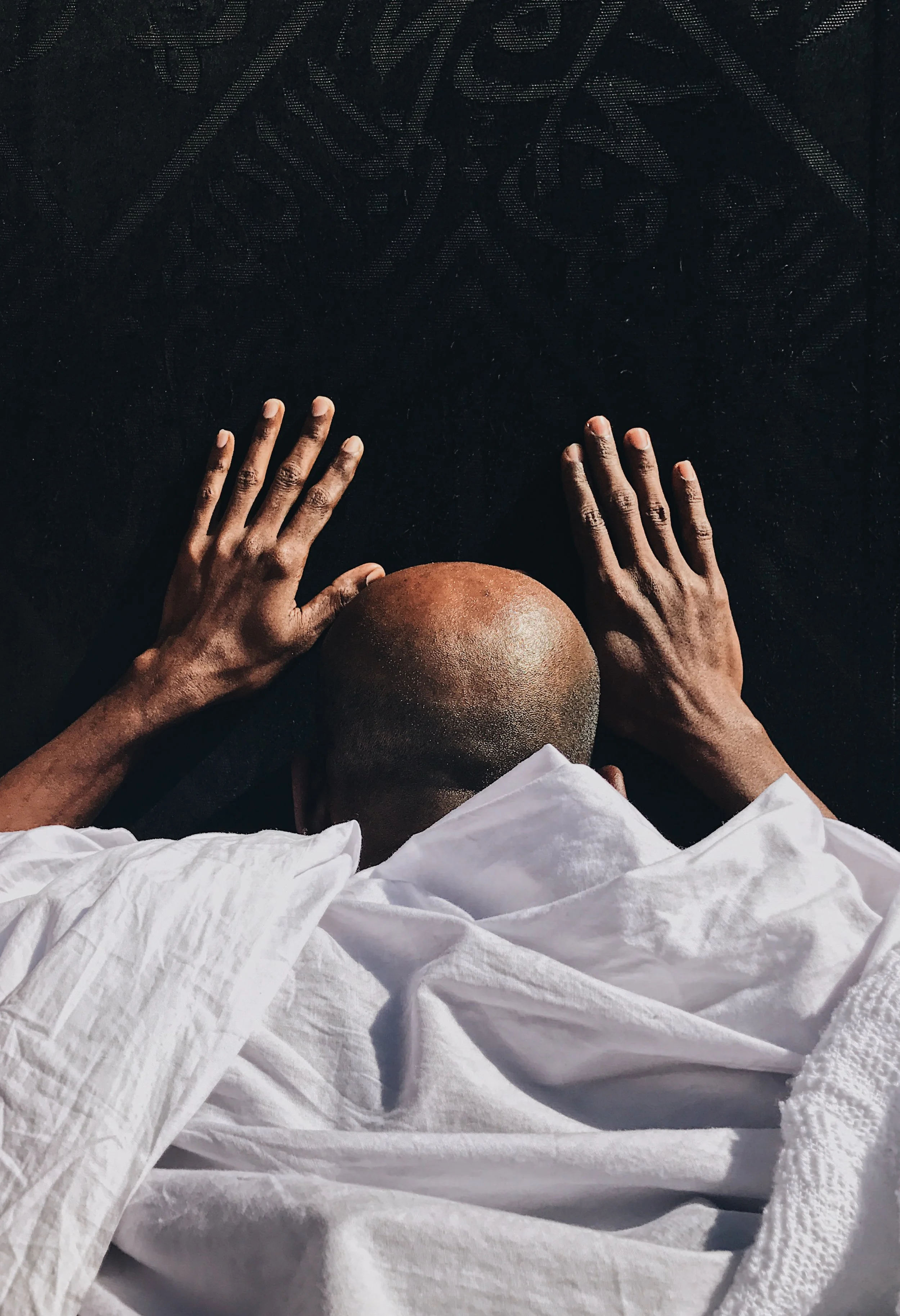  A pilgrim touches the Kaaba.  The Kaaba is draped in a silk cloth called a Kiswah. From afar, it looks like a plain black cloth but when the light hits it just right or when you move closer, you can appreciate the amount of work that goes into manuf