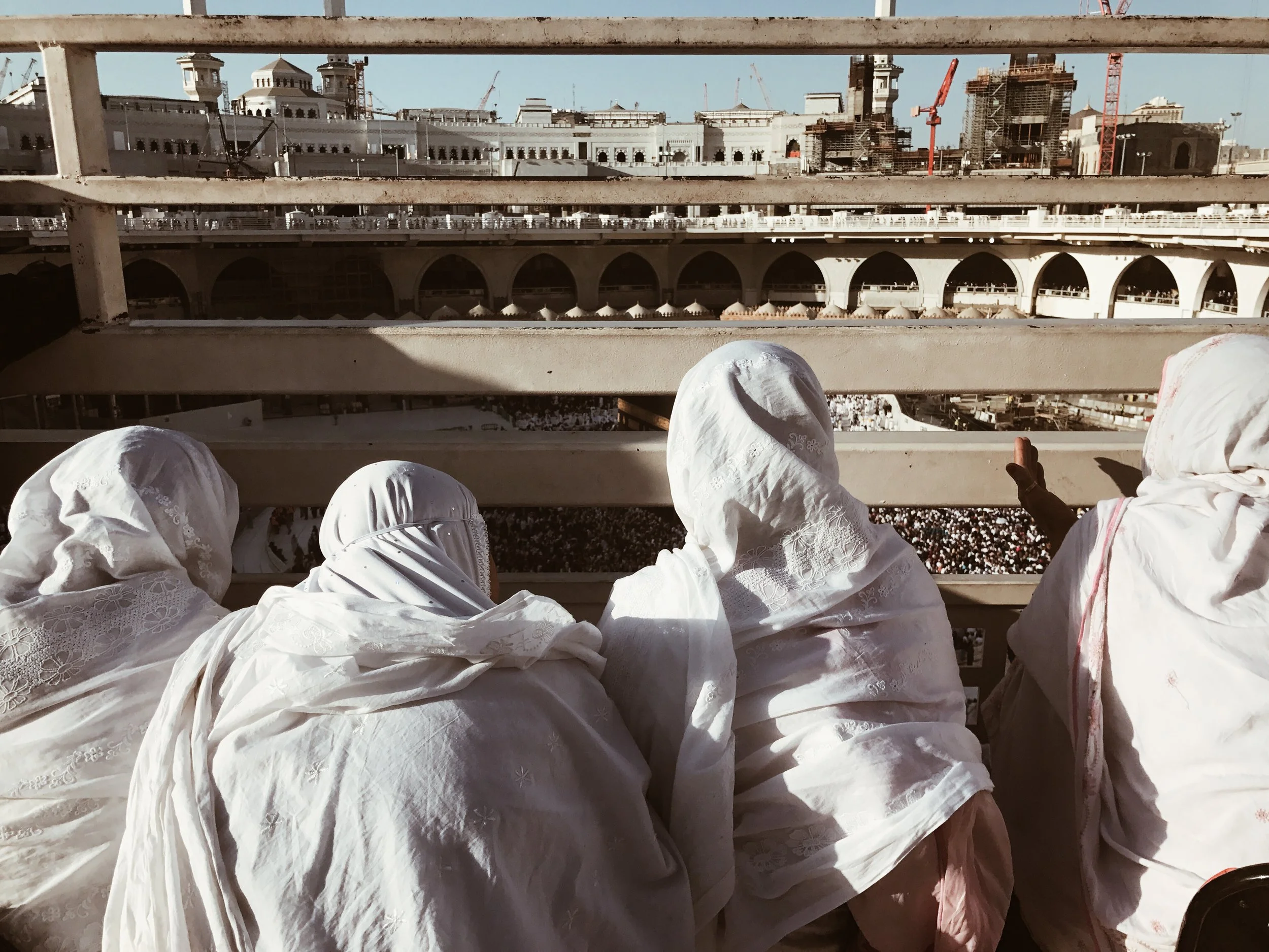 Four sisters look at the Kaaba from above while waiting for the sunset prayer.  