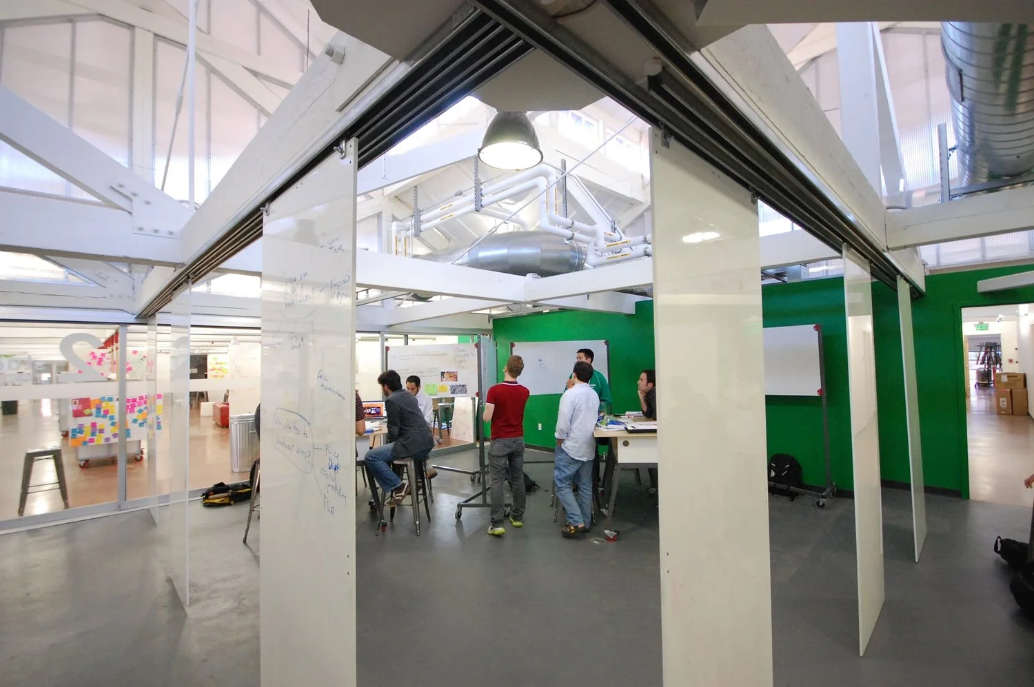 Whiteboard sliders and tables on casters allow students to set up impromptu workspaces.