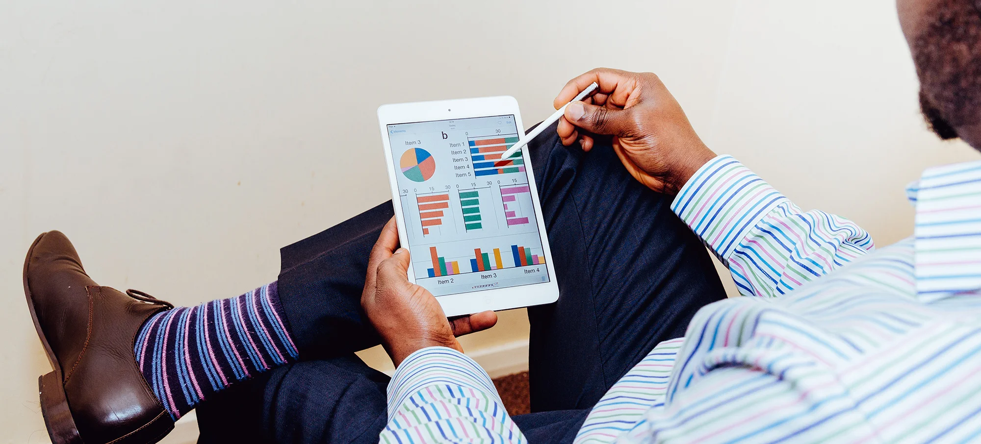 Man Working on Pie Charts on Tablet.jpg