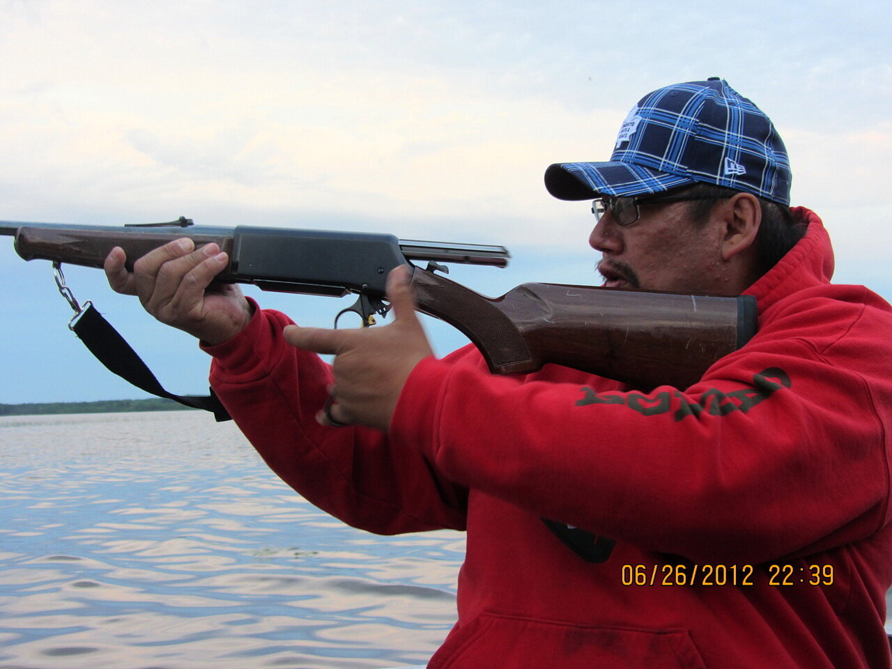 Photo 4: Harry Martha Papah in action, taking aim at a moose on Eabamet Lake, in the homeland of Eabametoong First Nation (Ontario), June 26, 2012.