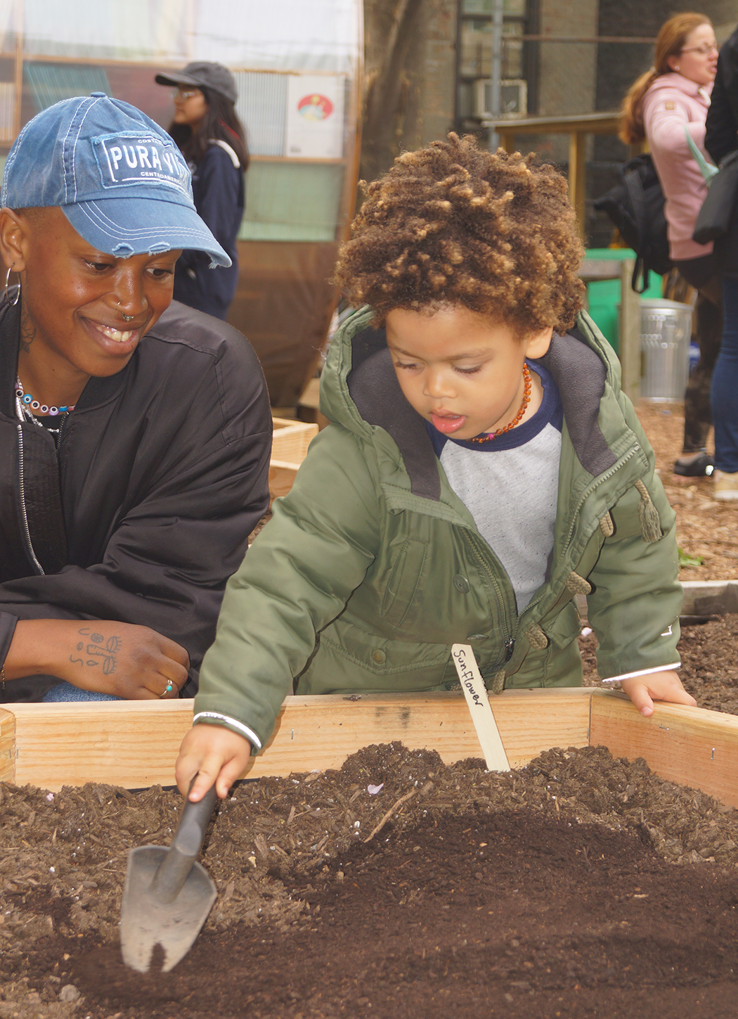 Child and Parent Shoveling Plant Bed at 2023 Earth Day Festival 2.png