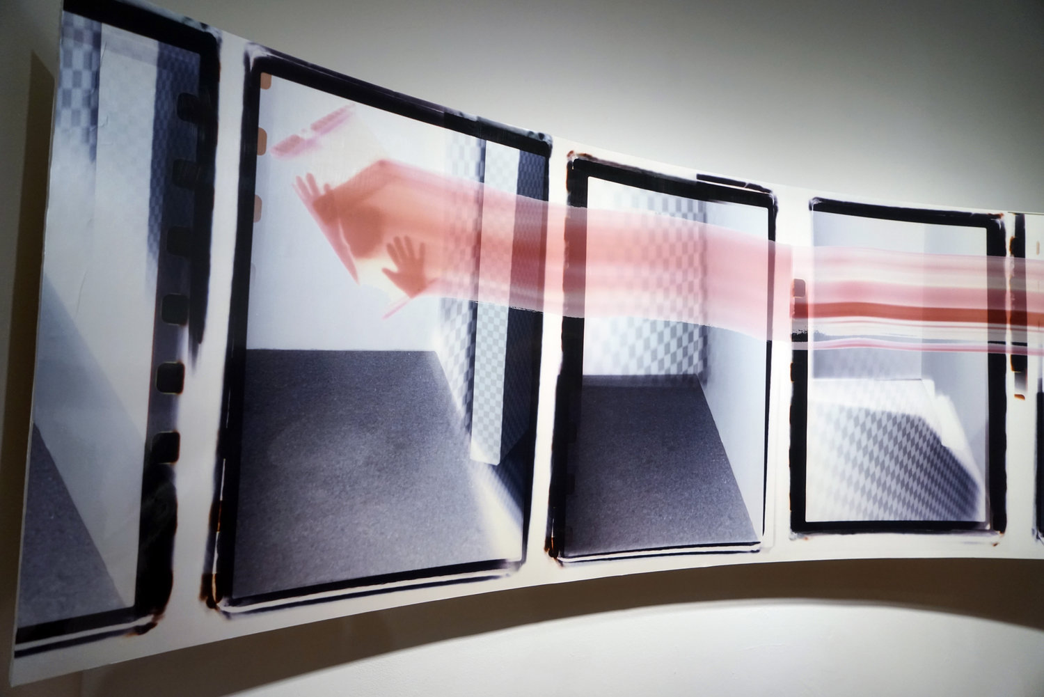 Elsie and Frances_01 Elsie and Frances_01 is an installation of a unique concave frame, made out of Baltic plywood, hung on the wall with a digital chromogenic print mounted to its surface. The image is produced with chromogenic prints made in the darkroom using double exposures and camera-less printing on an iPhone. Near this panoramic image is an automatically advancing slide projector lighting an invisible cube with slides handmade out of universal flash gel lighting filters.