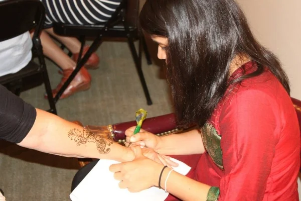 Our friend Trupti, offering her talents at the henna table.