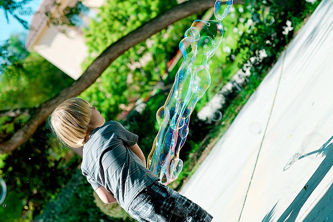 boy making bubble outside.jpg