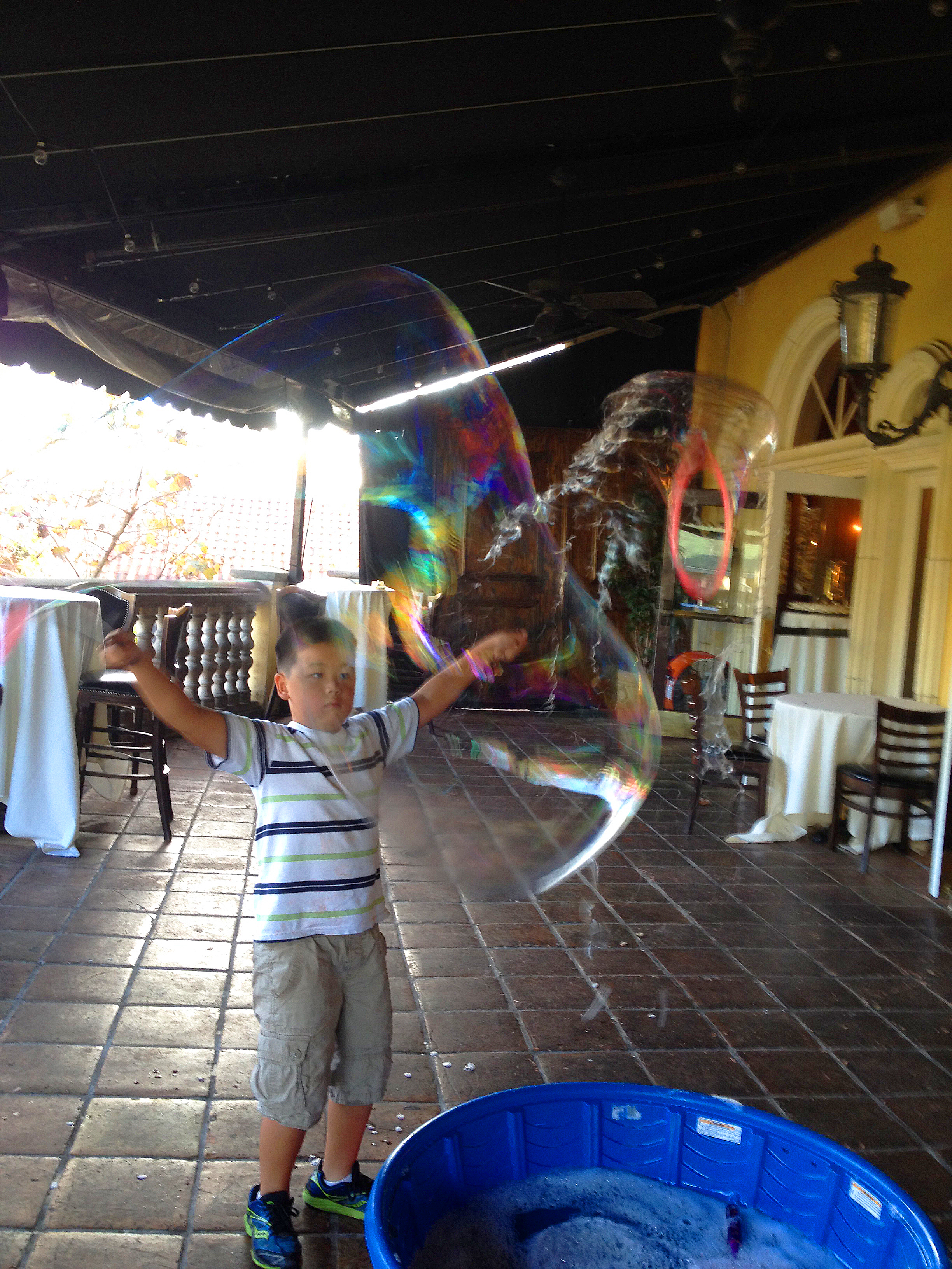 kid making bubbles at maggiano's.jpg