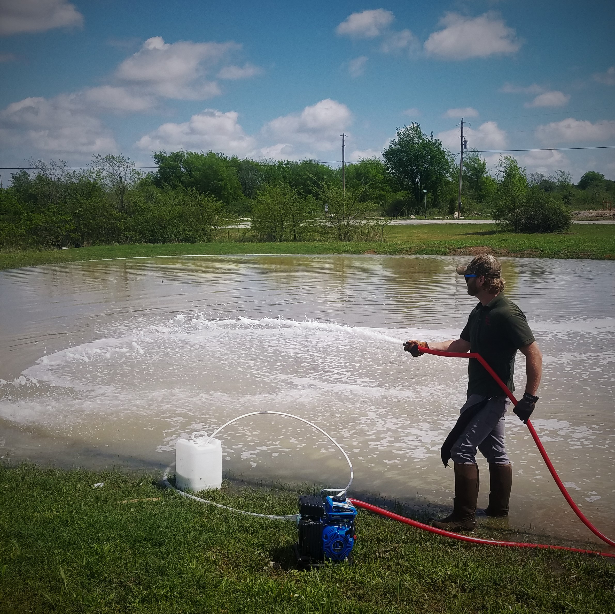 JarrydAppliesPondSealantToCollinsvillePond.jpg