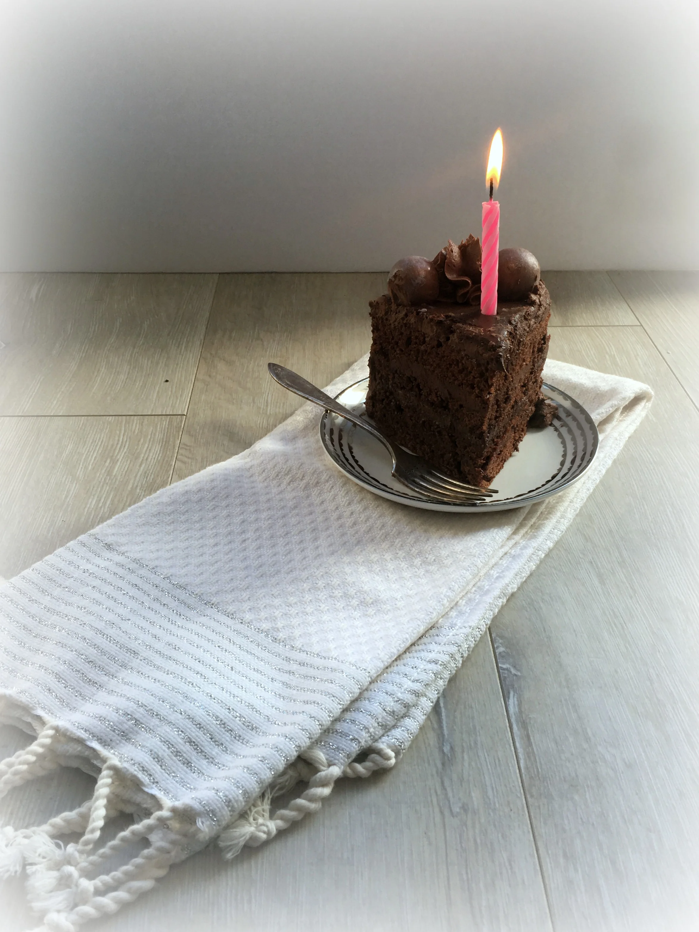 A rich moist triple chocolate cake that contains a chocolate ganache filling with a chocolate buttercream frosting and chocolate ganache glaze