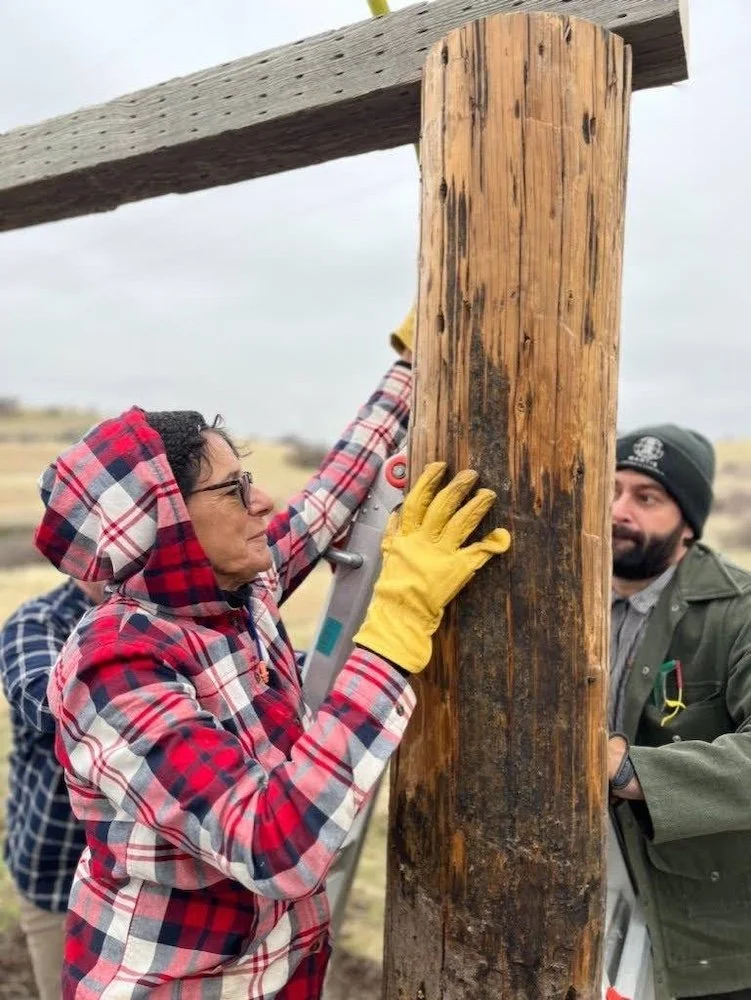 Person holding post steady