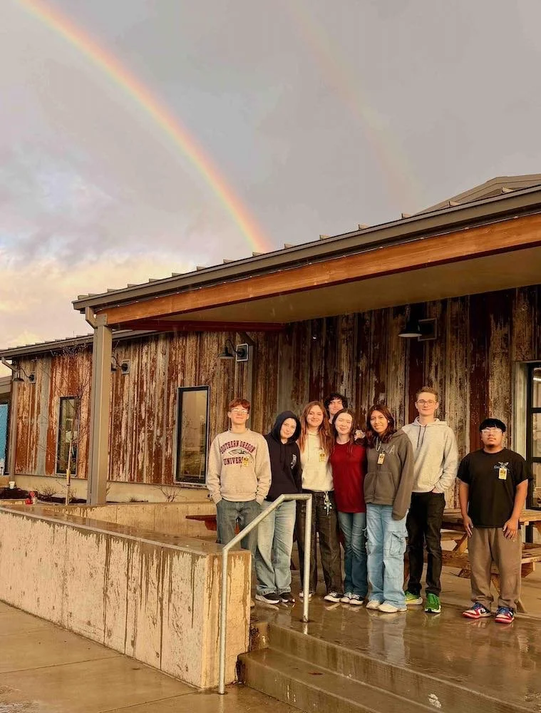 group of interns at Talent Maker City in front of a beautiful rainbow