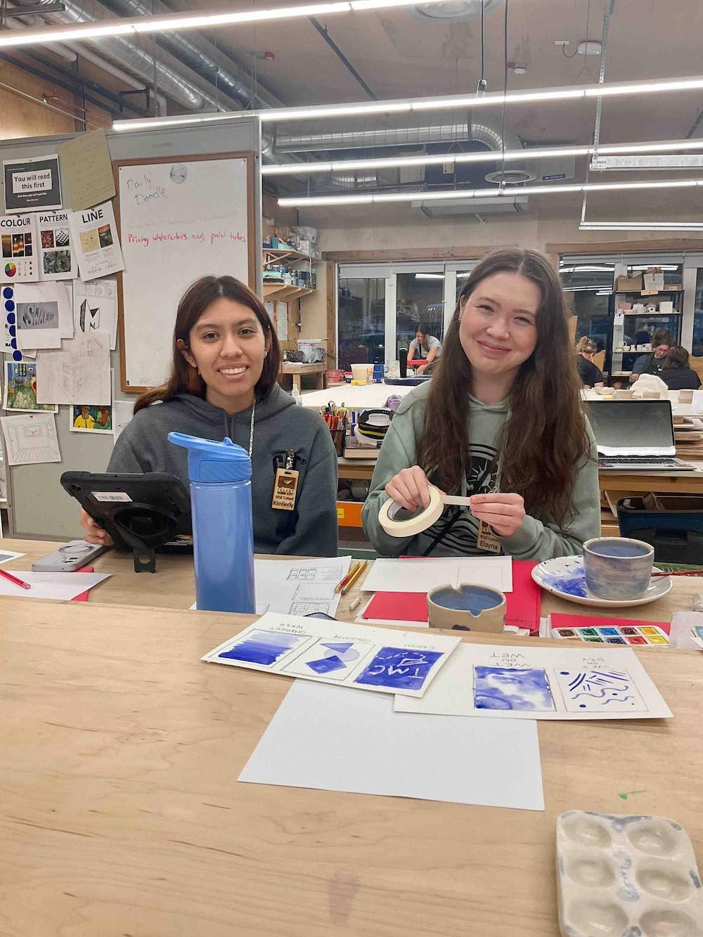 Two interns work on watercolor kit