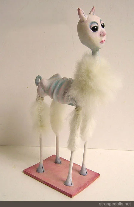 She is 10.5 inches tall. She is made with polymer clay and Apoxie Sculpt. 