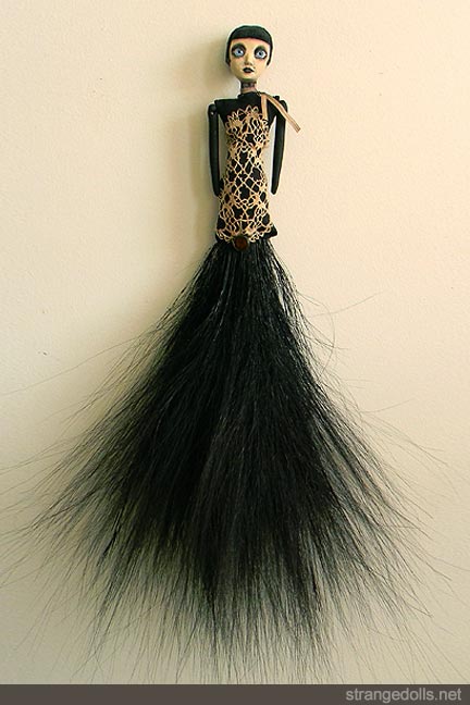 This doll is made to hang on the wall. She was made in 2011.