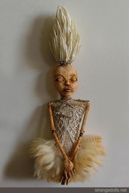 She is 13" tall. This piece has a hanger on the back of the head and is made to hang on the wall. Made in 2012.