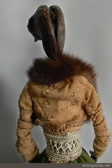Rosalie is 23" tall. Her head is a 'mysterious material'. I saw it, was inspired by the shape and fashioned a head from this object. Her stole is real beaver fur.