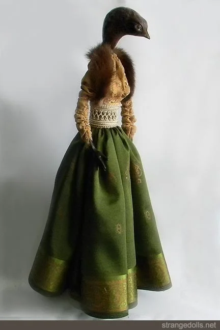 This piece was created for a series I did called "Gourds and Ghosts". It was a series of gourd dolls and the images mixed in with antique photos of women in my family. She was created in 2011.