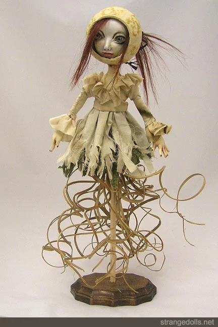 The Flower Girls are 16" tall. Their faces were sculped from polymer clay and painted. Their hair is real human hair.