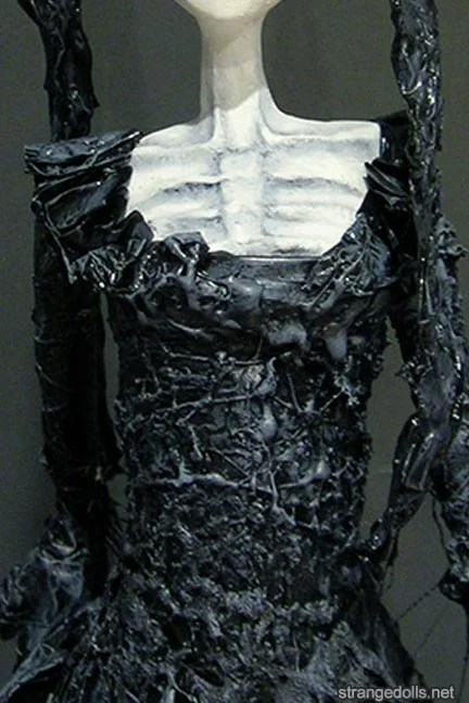 The dolls' clothing are made from combining a mixture of wire, rubber, plastics and cheesecloth. The clay parts are hand sculpted from a mix of air dry clays and plaster. I adore expressing decay in doll form through the use of burned plastics and exposed wire armature (the “skeleton” of dolls).