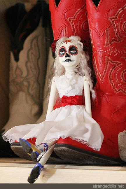 The doll is 12 inches tall. The arms, legs, and head are cast in resin from an original sculpt. Her clothing is hand sewn and the boots were sculpted out of polymer clay and hand painted. She was made in 2016 for Pamela.