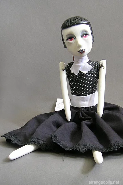 This doll is a cross between Louise Brooks and Theda Bara. She has a simple, flapper style with sharp fangs! She is made to hang on the wall, she has a wire hanger on the back of the head, or she can sit on a shelf. I created several of these dolls in 2013.