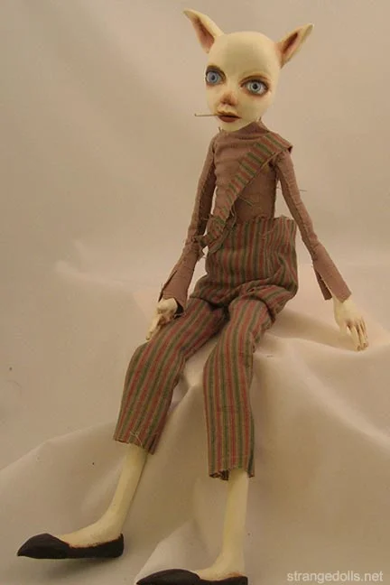 Buster is 21" tall. He is handsculpted using Paperclay and Apoxie Sculpt. The cigarette is removable. He is a bit of a rascal.