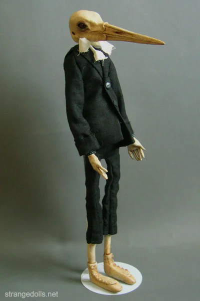 All of his clothing is hand sewn. No patterns were used. His black suit is a cotton twill. His bow tie is 100% cotton that has been tea stained to give it that ecru color.