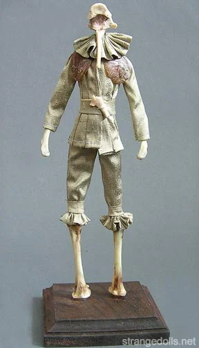 This dapper piece is made from the remnants of Thanksgiving dinner. His head, hands, and legs are turkey bones and his clothing is hand sewn from vintage fabrics.