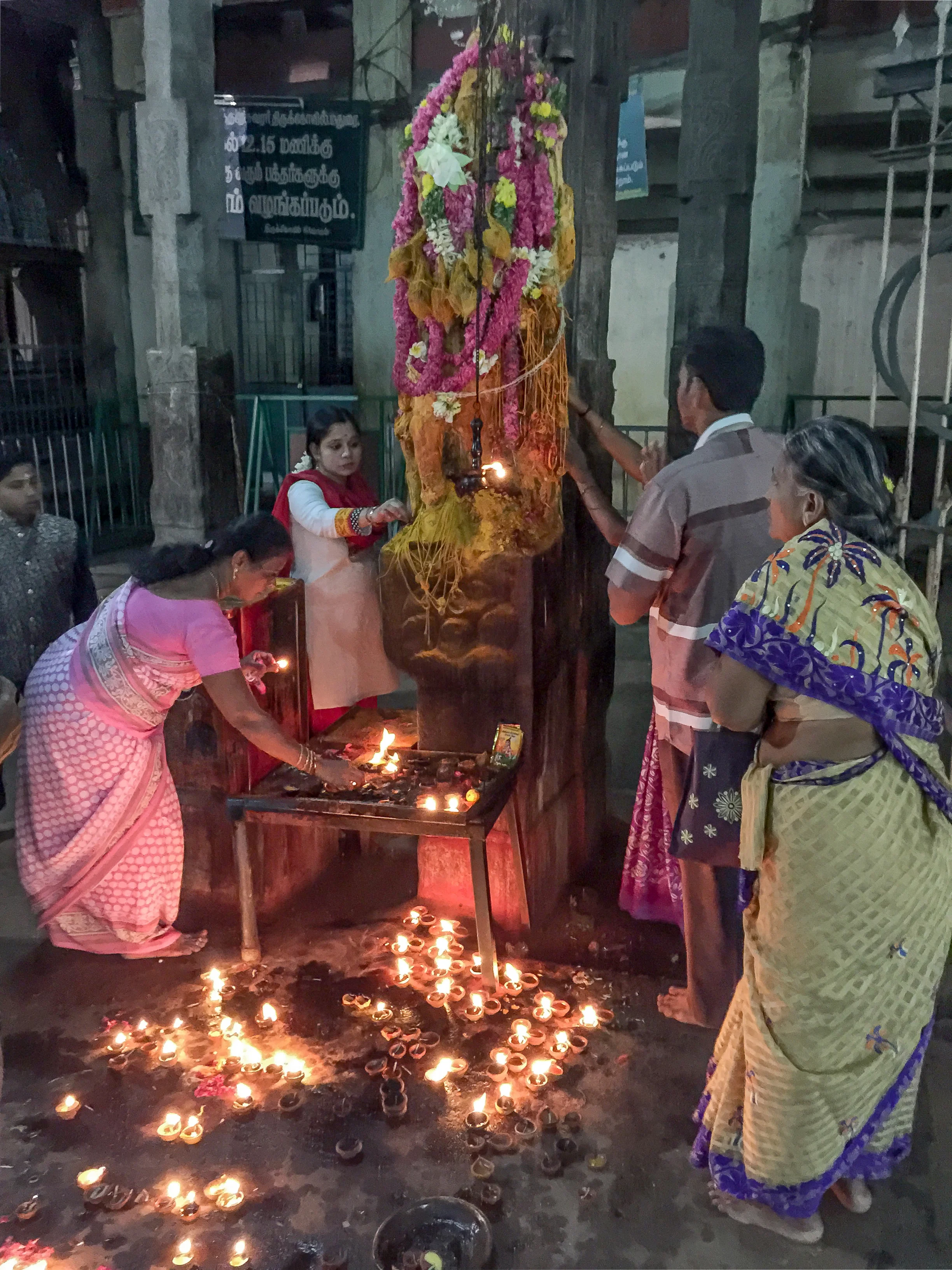  Hindus worship some deities that have no recognizable anthropomorphic characteristics. This shrine's votive figure is ritually honored by attaching string to it. 