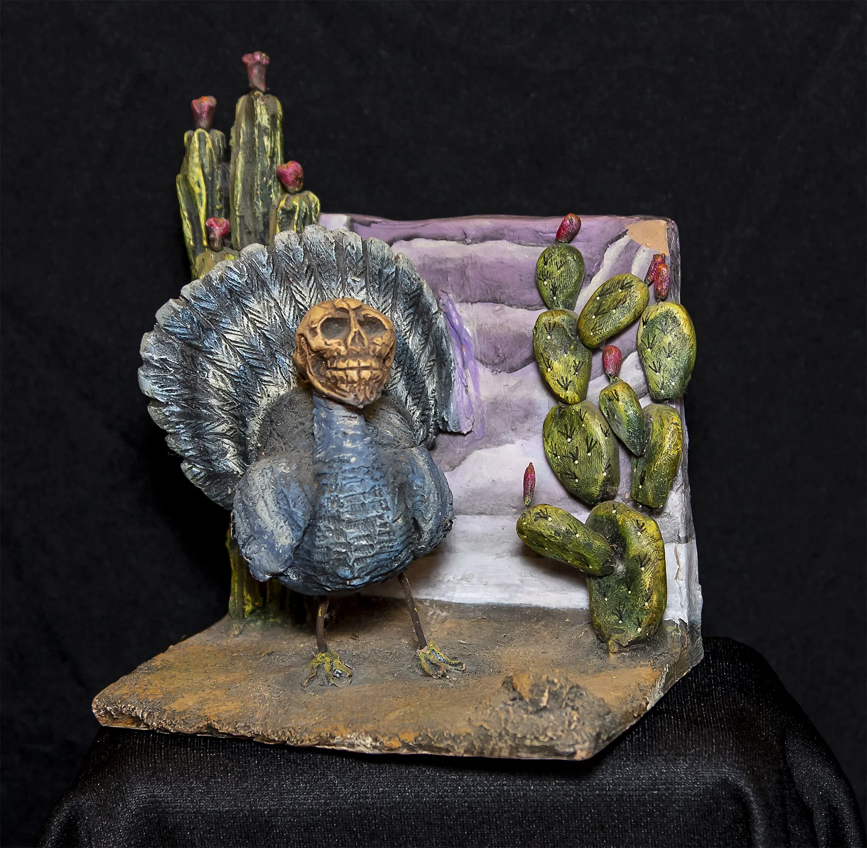 Ceramic and wire turkey with skull head. 13.97 cm square.